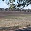 A number of people walk through a dry creek bed