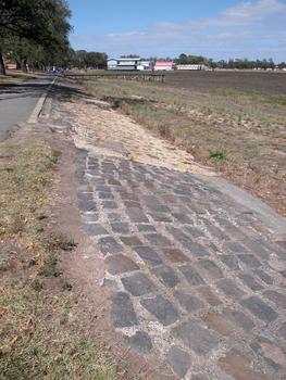 A bluestone edge is exposed at the edge of a dry lake