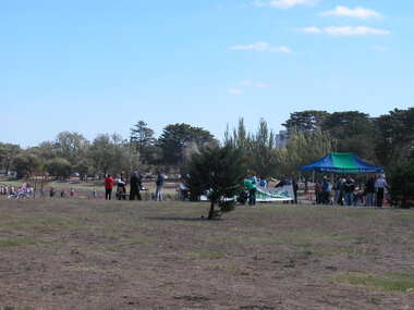 A number of people walk thorugh a dry lake