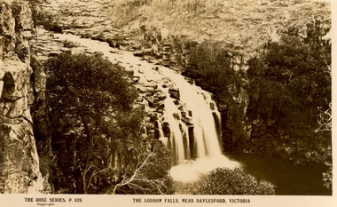 A waterfall flows over a rocky gorge