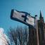 A white flag with blue edge and cross blows in the wind