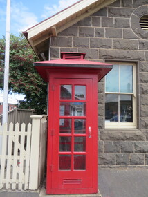 Phone box in front of a bluestone post office