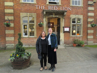 Two women in front of Lacock National Trust Village, United Kingdom