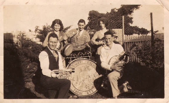 Five musicians are photographed with their instruments