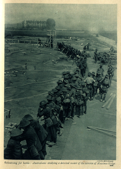 Australian troops stand around the edge of a model of the Messine Ridge