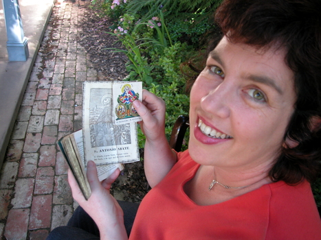 A Woman holds a book with two old holy cards