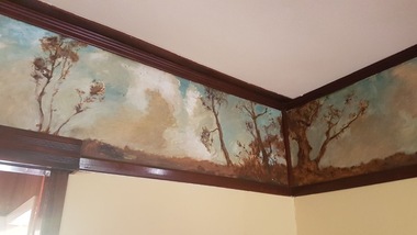 A painted frieze on a cottage wall