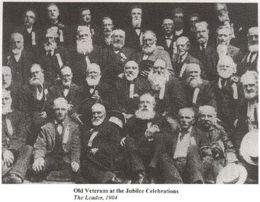 A number of old men wearing a ribbon