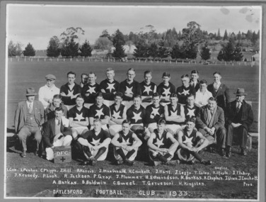 A football team wears a star on their jumper, and sits for a team photograph