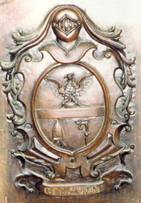 A carved family crest in timber