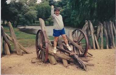 A man stands on an old waggon