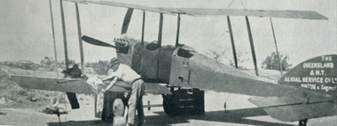 Man with a  Hudson Fysh Cleans a B.E.2E Qantas aeroplane at Thargomindah after joy-riding.