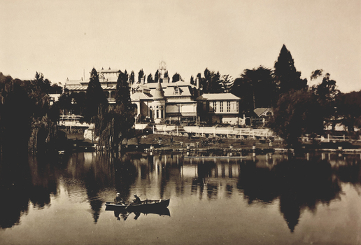A mansion behind a lake