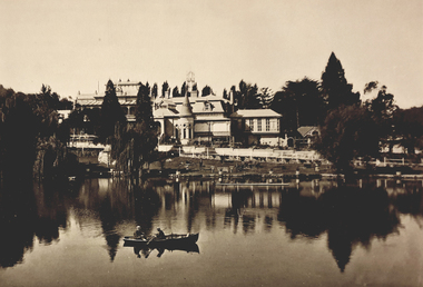 A mansion behind a lake