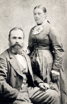 A man sits and a woman stands