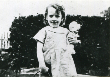 A girl holds a doll