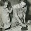 A woman and child ironing