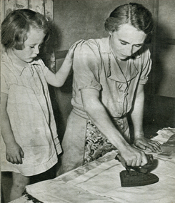 A woman and child ironing