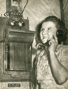 Image - Black and White, Woman on a party-line wall telephone, c1950, c1950