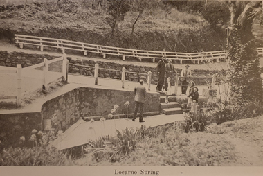 A number of people stand around a spring at Hepburn