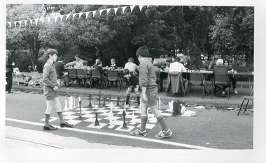 Two school boys play chess