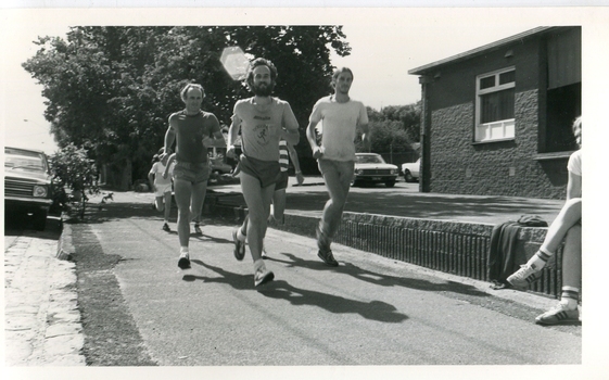 men running along a footpath