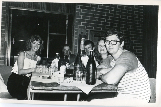 A table of people at a colonial dance