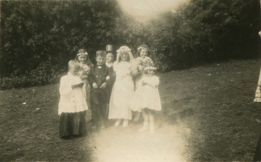 A group of children dressed as a wedding party