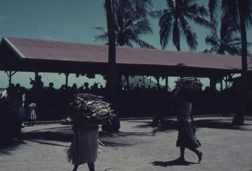 Koki open air Market showing Papuans carrying produce.