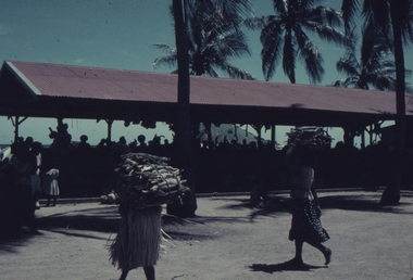 Koki open air Market showing Papuans carrying produce.