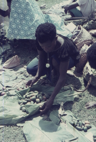 This photograph shows a Papuan with produce at Koki Markets.