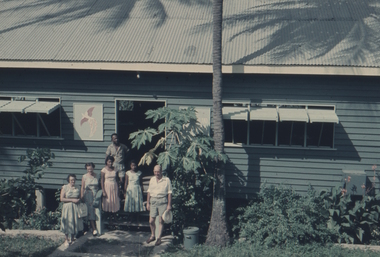 This image shows a bird of paradise, an emblem of PNG on display at the left hand side of the door. Standing in front are Elwyn Kinnane and David Kinnane.