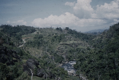 Image shows the fast flowing river and the winding road to Sogeri.