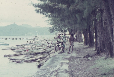 Canoes and Papuans on the harbour in New Guinea.
