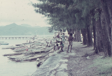 Canoes and Papuans on the harbour in New Guinea.