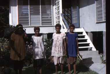 Papuan ladies at the front entrance of the Kinnane house in New Guinea.