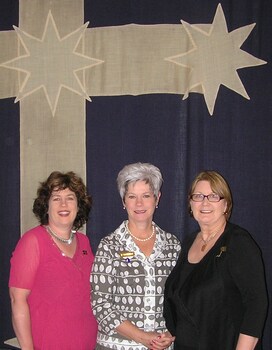 Three women in front of a Eurkal Flag