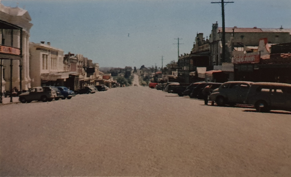 A streetscape with parke cars