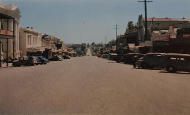 A streetscape with parke cars
