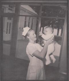 Photograph - School 78 First year nurse Cathryn Lillie - 1971 photo holding a baby(Susan Dixon)