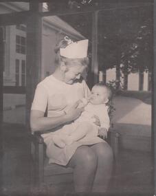 Photograph - School 78 - Student Nurse Cathryn Lillie bottle feeding Baby Susan Dixon 1971