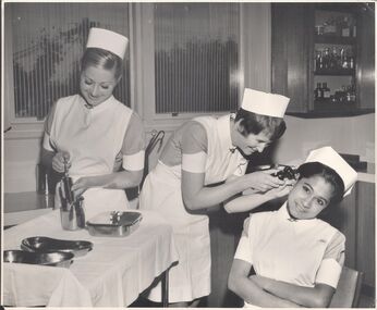 Photograph - School 70 - 3 First Year Nurses simulating examination of ear - Senior Demonstration Room