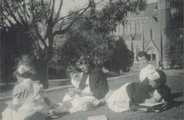 Photograph - Five PTS students sitting on lawn at Wattle Street Bendigo. 1954