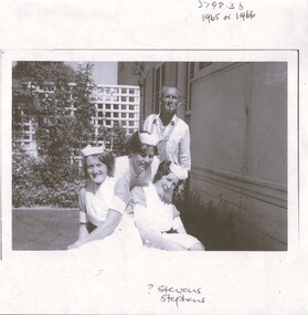 This is a photograph of four people on the lawns of Lister House. One is possibly the gardener.