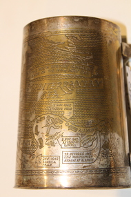Metal tankard with etched maps showing the African campaign during the Second World War.