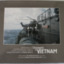 Photograph of four sailors watching a naval helicopter hover over the quarterdeck of HMAS Parramatta