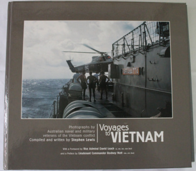 Photograph of four sailors watching a naval helicopter hover over the quarterdeck of HMAS Parramatta