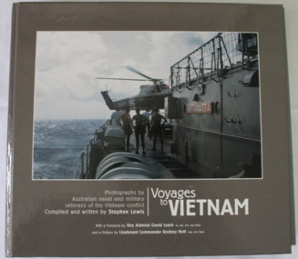 Photograph of four sailors watching a naval helicopter hover over the quarterdeck of HMAS Parramatta