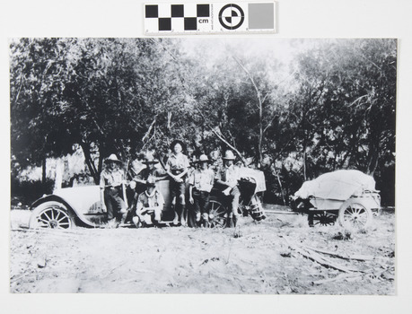 This image depicts Scout Master and scouts standing beside a 1918 Buick car with loaded trailer