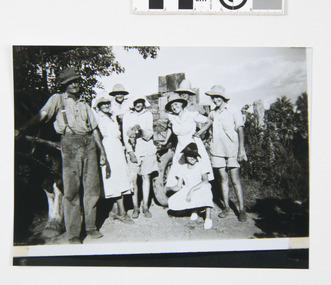 This image depicts the Curtis family including parents and 6 children in front of horse drawn trailer loaded with empty dip tins in their vineyard 